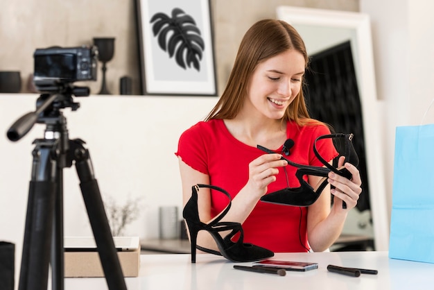 Blogger presenting high heels on camera