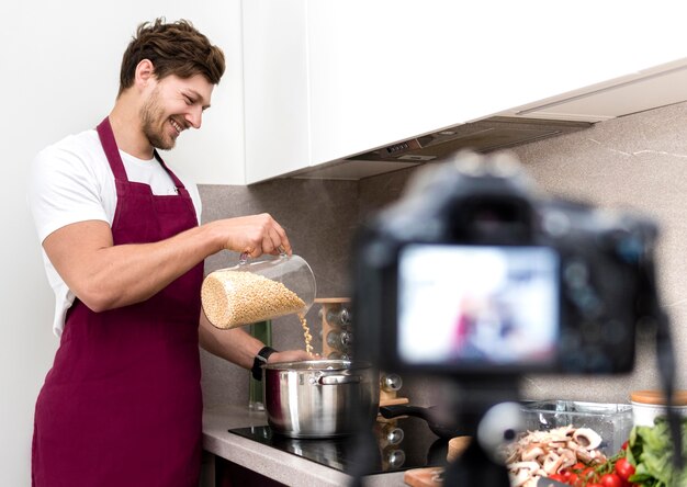 Blogger recording himself while cooking at home