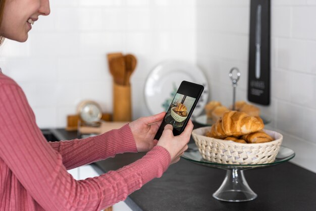 Blogger taking a photo of croissants