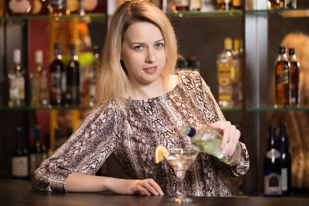 Blond girl bartender at work