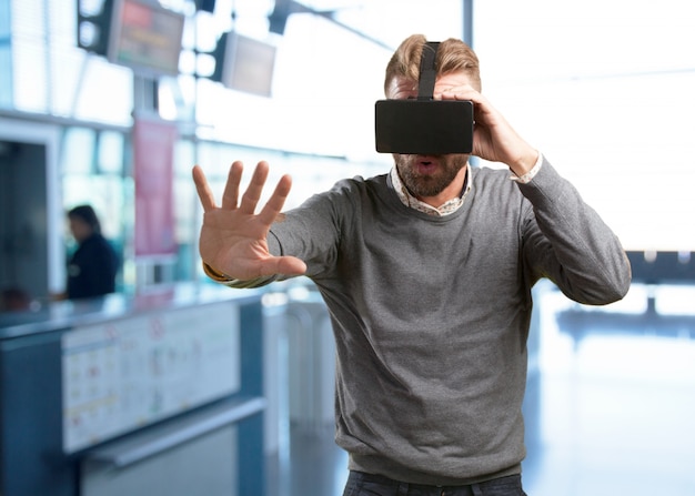 blond man with virtual glasses. surprised expression