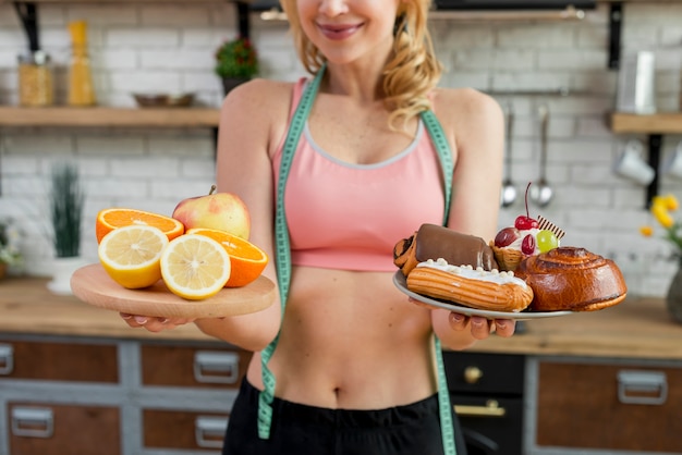 Blond woman in the kitchen with fruits