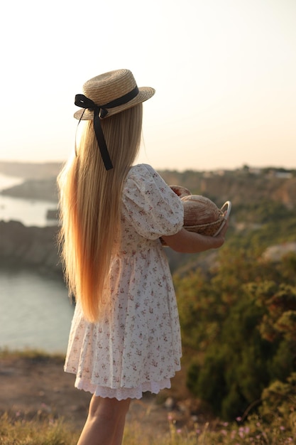 blond woman near beautiful sea view back side