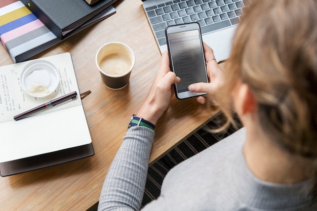 Free Photo blond woman texting on her phone