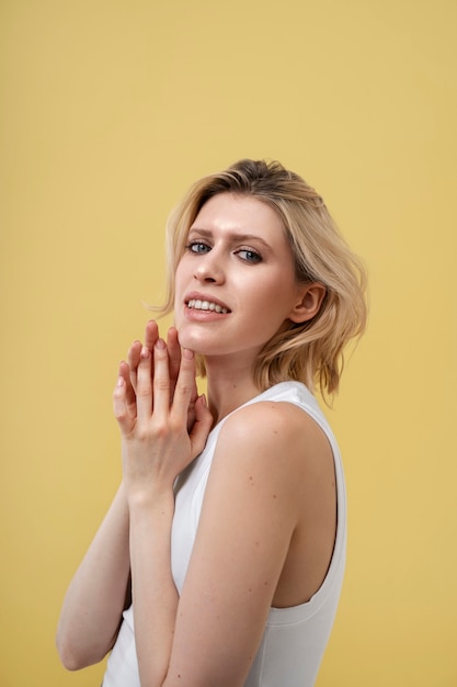 Blond woman with shiny skin posing