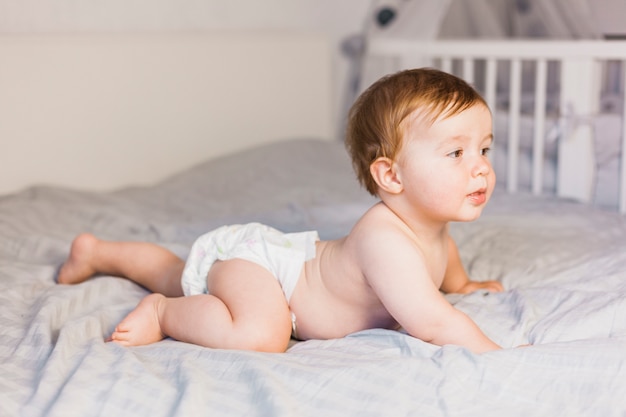 Blonde baby on a bed