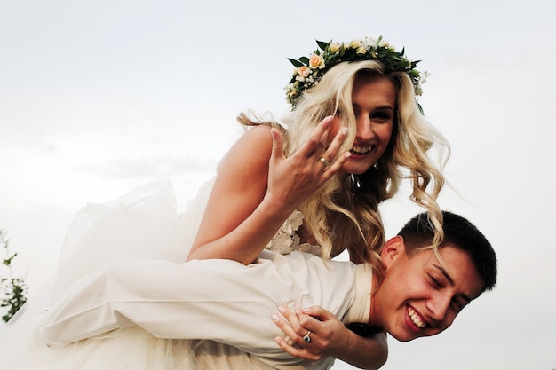 Free Photo blonde bride riding a horse on her husband