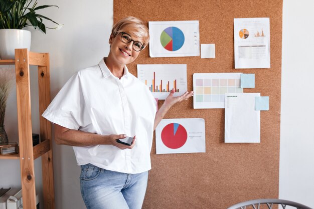 Blonde business woman demonstrates charts on board