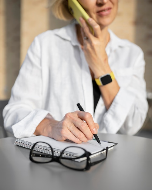 Free photo blonde business woman talking on her phone