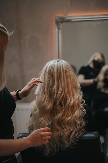 Free photo blonde female getting a new hairstyle at a hair salon