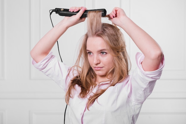 Blonde girl doing her hair