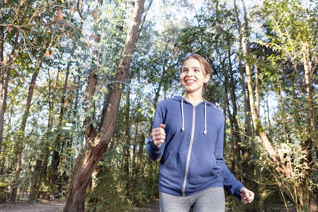 Free Photo blonde girl enjoying while running outdoors