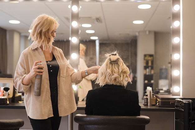 Free photo blonde girl getting her hair done