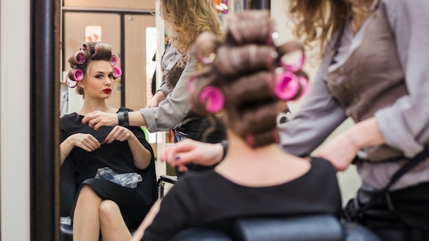 Free photo blonde girl getting her hair done