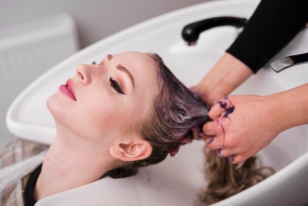 Blonde girl getting her hair washed