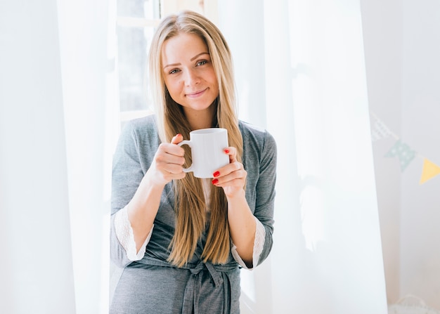 Blonde girl having coffee in the morning