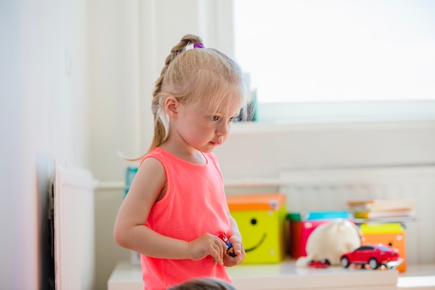 Free photo blonde girl holding toy