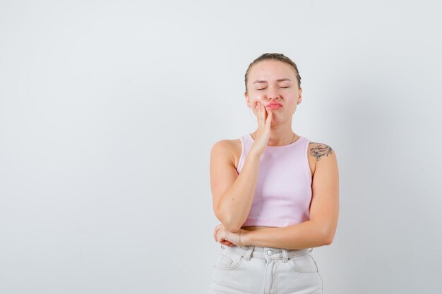 Blonde girl is offended by something  on white background