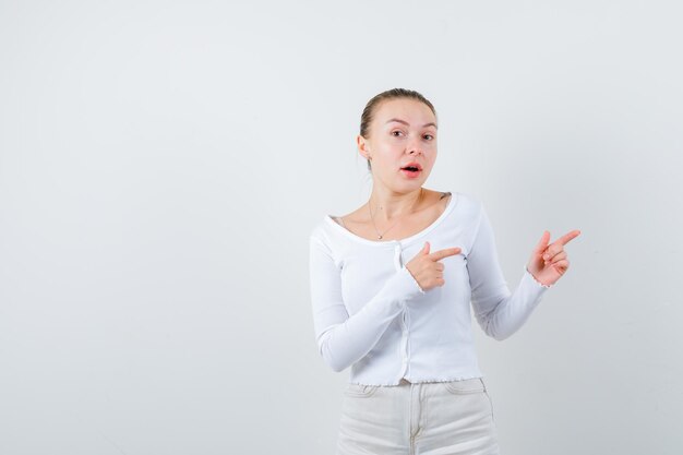 Blonde girl is showing right side on white background