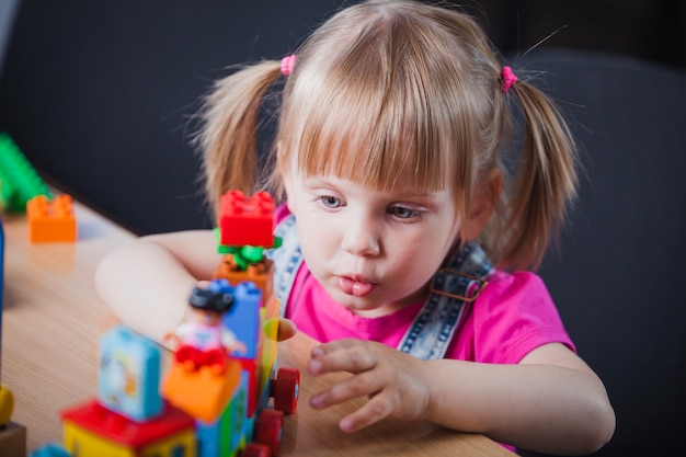 Free Photo blonde girl playing with toy train