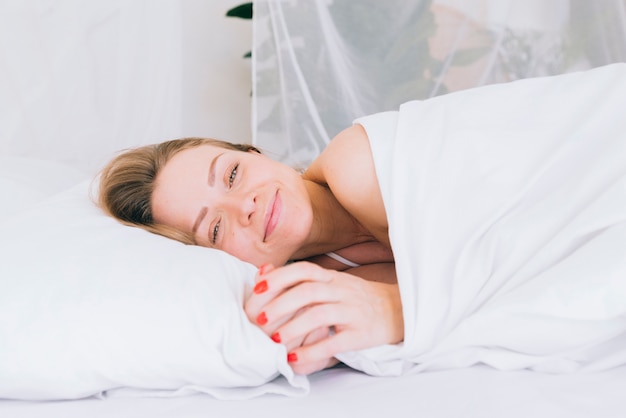 Free photo blonde girl posing on the bed