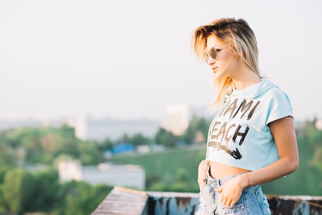 Blonde girl posing on rooftop