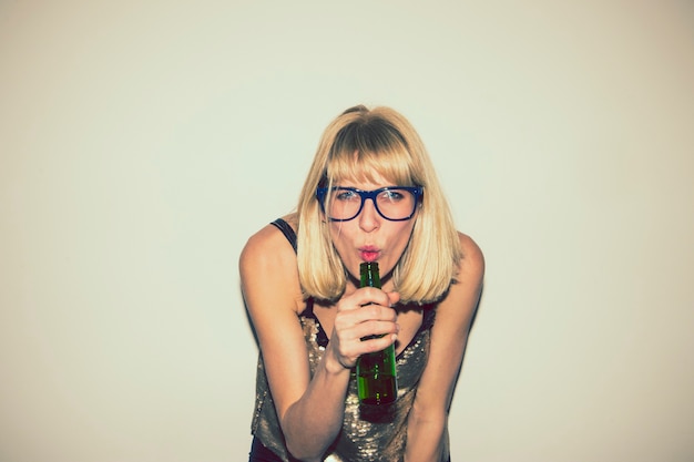 Blonde girl posing with a beer