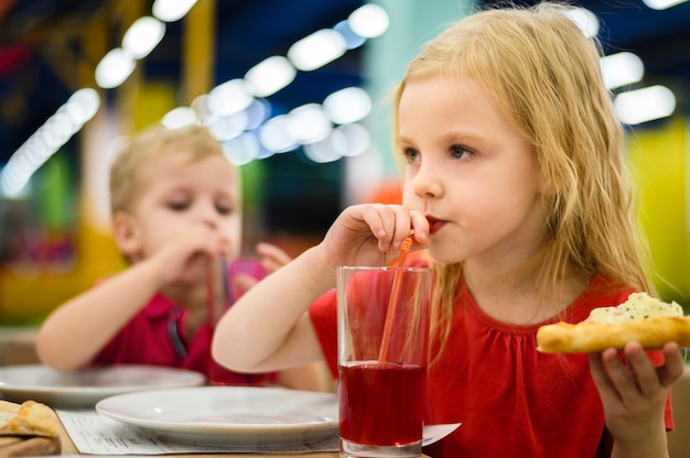 Blonde girl sipping juice