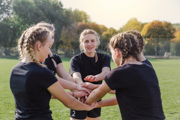 Free photo blonde girls putting hands together