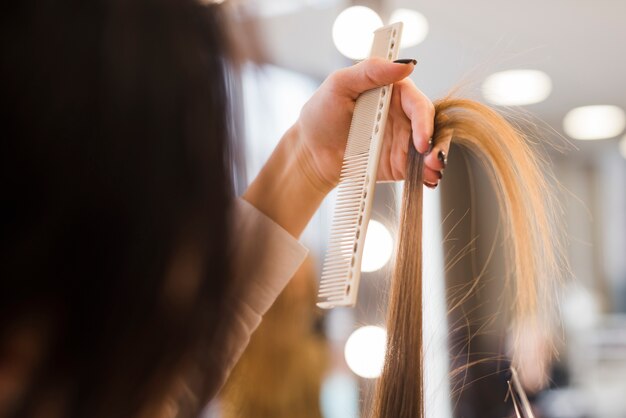 Blonde hair being brushed