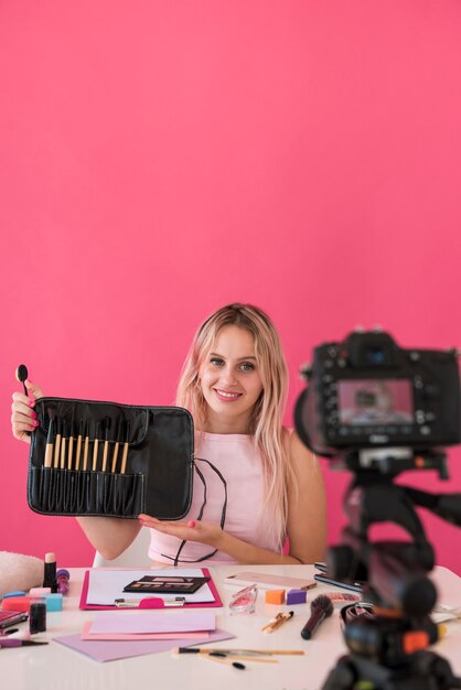 Blonde influencer recording make up video