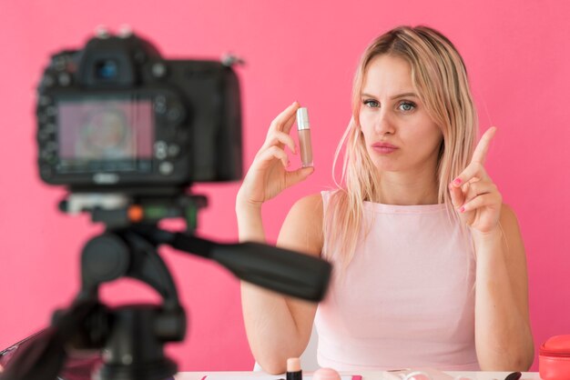 Blonde influencer recording make up video