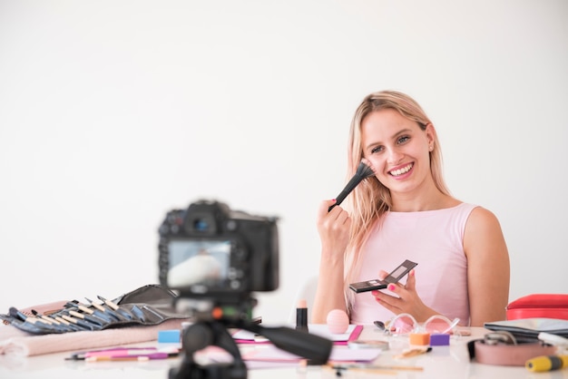 Blonde influencer recording make up video