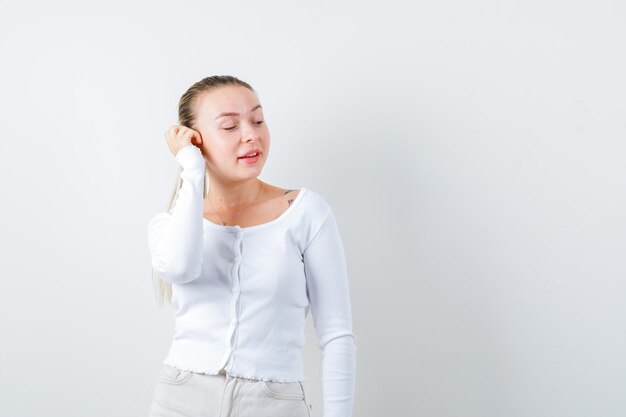 Blonde lady is calling to somebody on white background