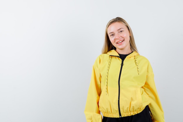 Free Photo blonde lady looking at camera in tracksuit and looking merry , front view.