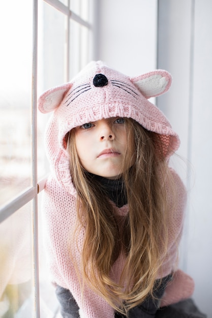 Blonde little girl wearing pink pullover