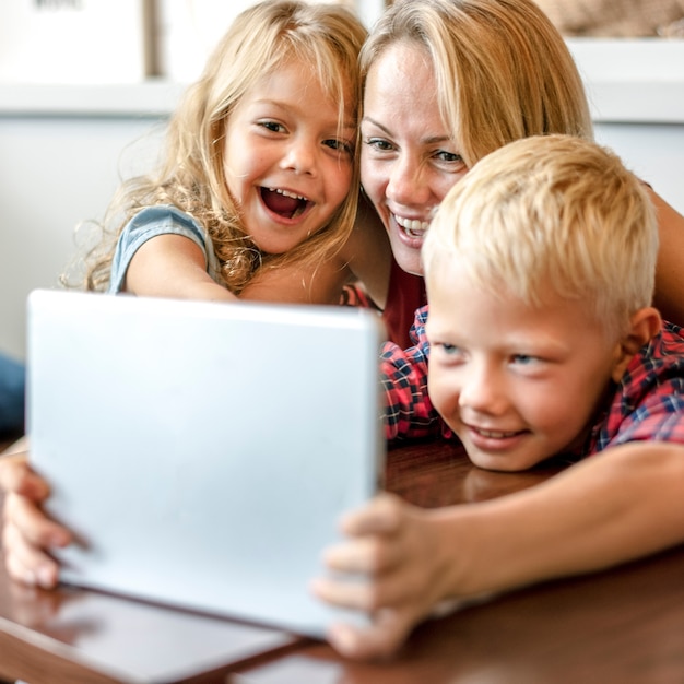 Blonde mom and kids making a video call on a tablet