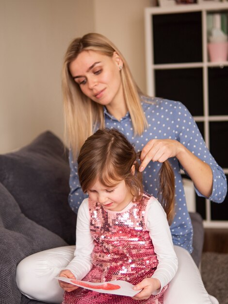 Blonde mother and young daughter together