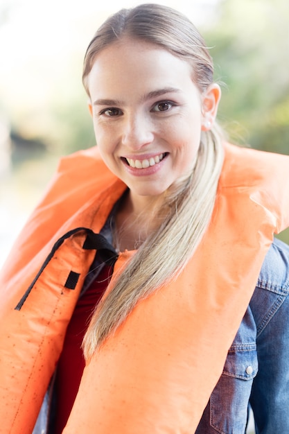 Free Photo blonde teenager posing with a life jacket