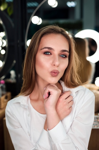 Free photo blonde woman blowing a kiss