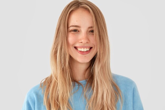 Blonde woman in blue shirt posing