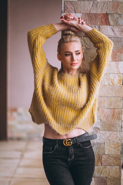 Free photo blonde woman in cool yellow sweater