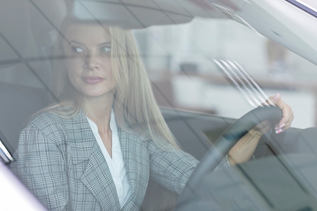 Blonde woman driving the car carefully