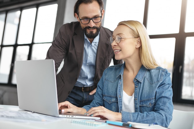 Blonde woman having conversation with work colleague