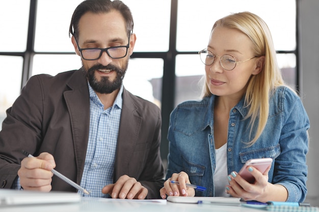 Blonde woman having conversation with work colleague