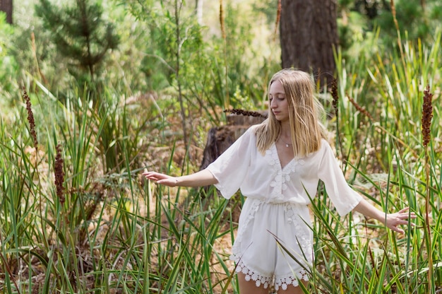 Free Photo blonde woman looking down in the park