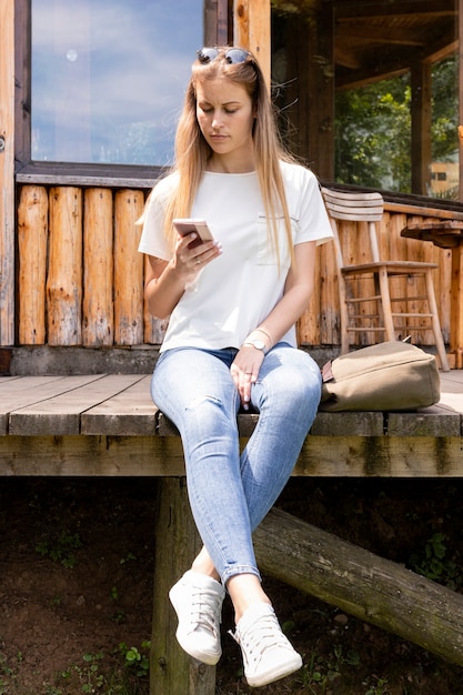 Blonde woman looking at her phone