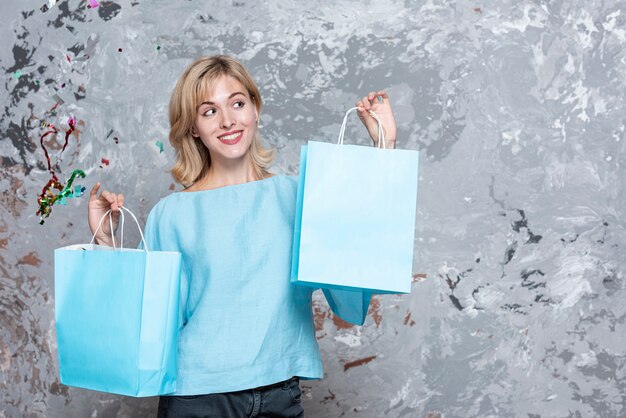 Blonde woman looking at paper bags