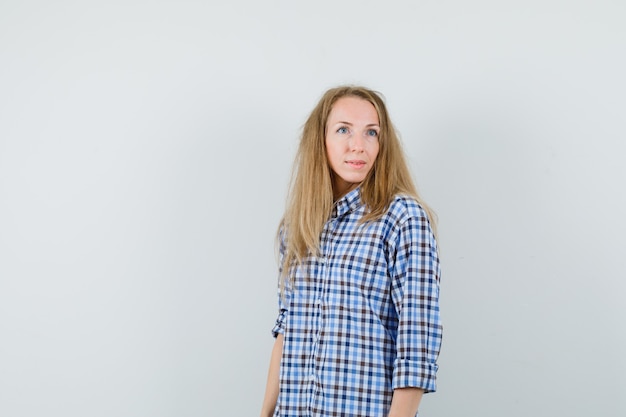 Free photo blonde woman in shirt looking away and looking dreamy ,