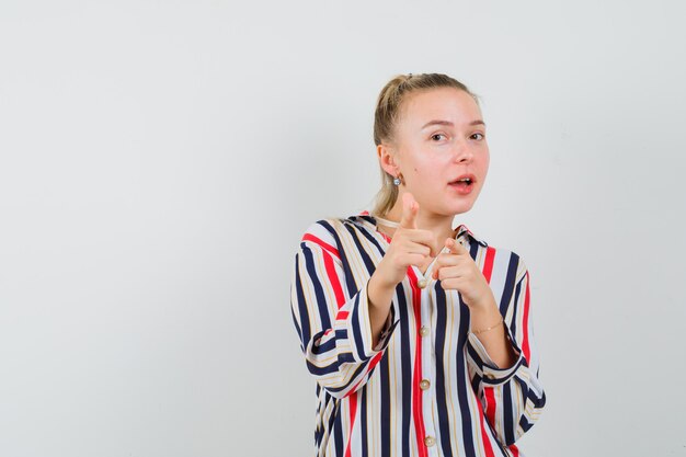 Blonde woman in striped blouse and looking happy